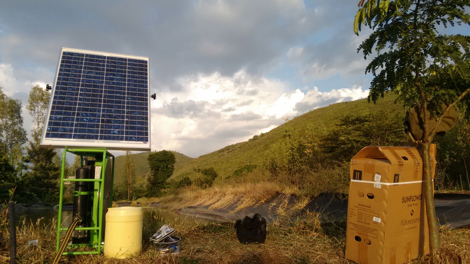 Unpacking a Futurepump solar pump on a farm next to a fish pond