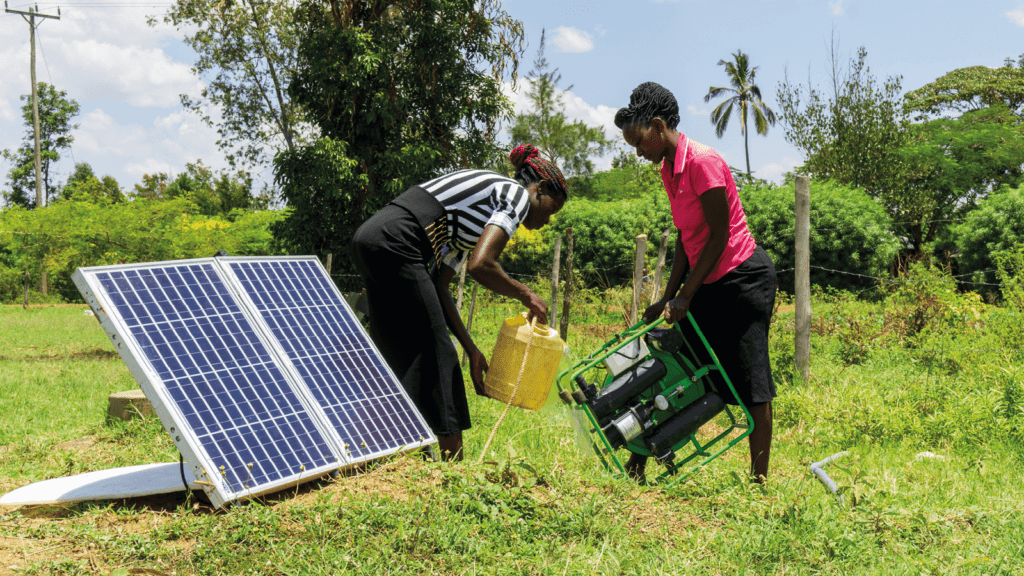 Two women set up a Futurepump solar pump near a well at a school. water pumps for irrigation