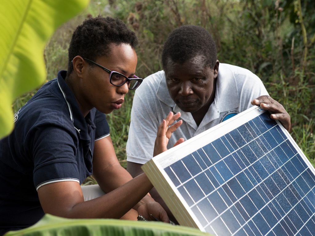 Kinya explaining the solar panel connection as part of the warranty service