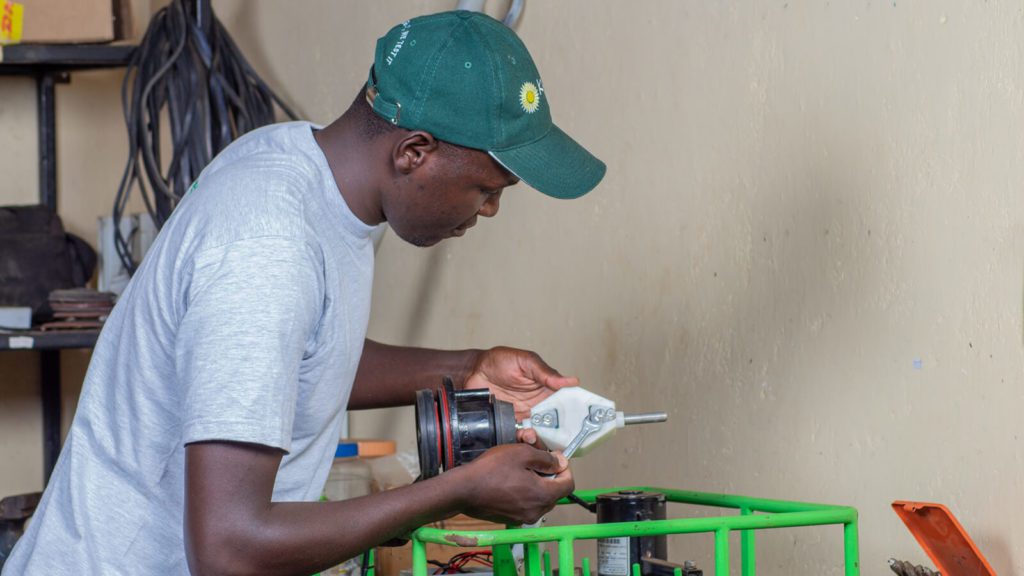 Kijani technician looking at a Futurepump solar pump yoke which is going to be tested