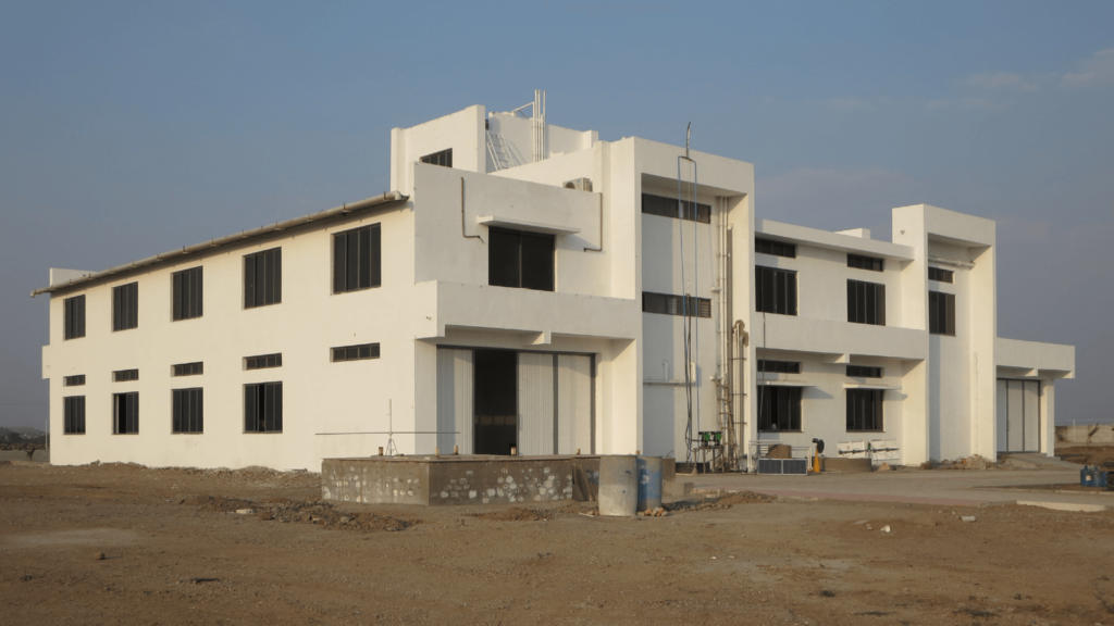 A large white building in front of a blue sky. The Futurepump solar water pump factory in Rajkot, India.