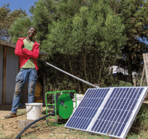 One of Peter's farmhands with their SF2 solar water pump and solar panel.
